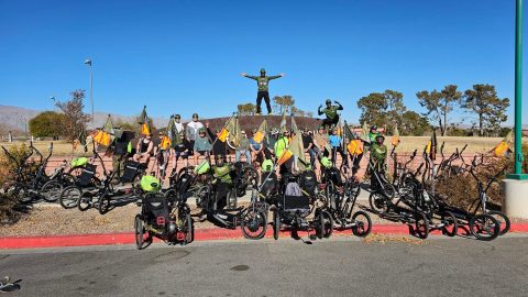 Large group of veterans and adaptive trikes gathered for a photo at Craig Ranch Park.
